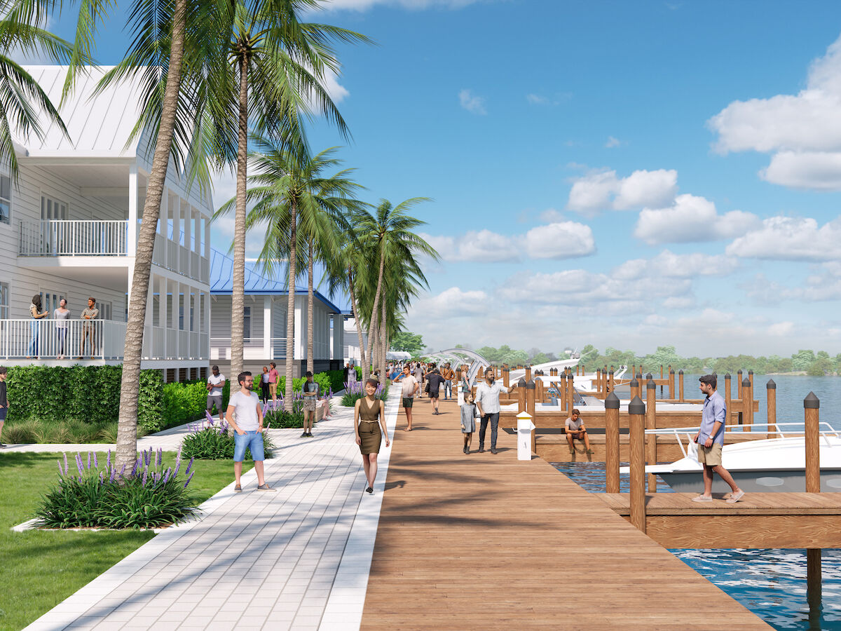 A waterfront scene with people walking along a boardwalk, boats docked nearby, and palm trees lining the path under a blue sky.